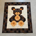 #461 Babyteppe brun/oransje bamse